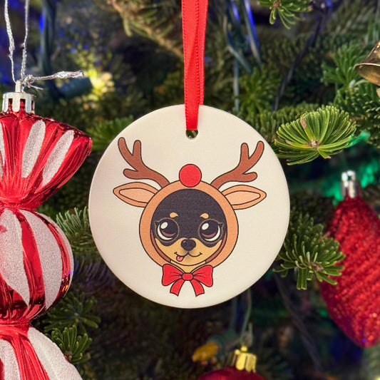 Decorative reindeer ornament hanging on a Christmas tree with colorful ornaments.