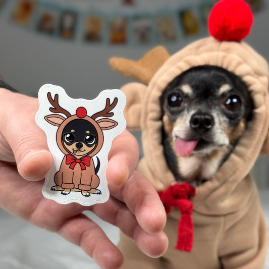Dog in a costume holding a sticker of a dog in a reindeer outfit.