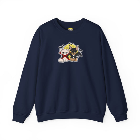 Navy crewneck sweatshirt with a centered illustration of two chihuahuas dressed in gentle vampire-themed outfits, sitting side by side under a yellow moon with small bats flying around them.