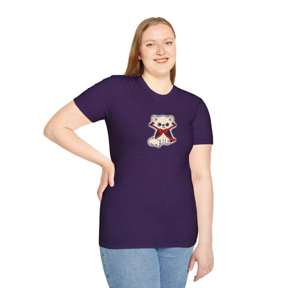 Person wearing a purple short-sleeve t-shirt featuring a centered illustration of Cedric the cream chihuahua sitting calmly in a black cape with red lining and a red bow, outlined by a soft pale glow.