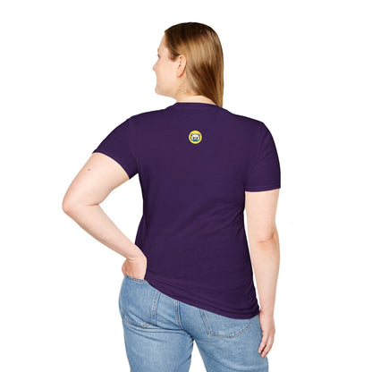 Person shown from the back wearing a purple t-shirt with a small round graphic centered below the neck, featuring Cedric the cream chihuahua in a black cape with red accents on a yellow circle background.