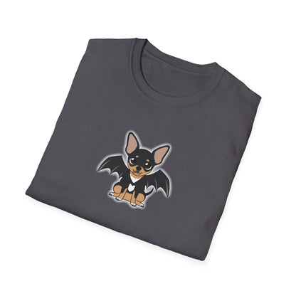 Woman sitting cross-legged on a living room floor wearing an orange t-shirt with a cute black-and-tan chihuahua character with bat wings printed on the chest.