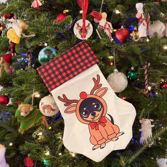 Christmas tree with a reindeer-themed stocking and various ornaments.