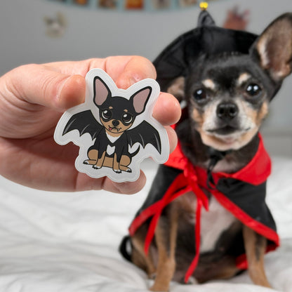 Die-cut sticker featuring Maya the Chihuahua in a vampire costume with bat wings.