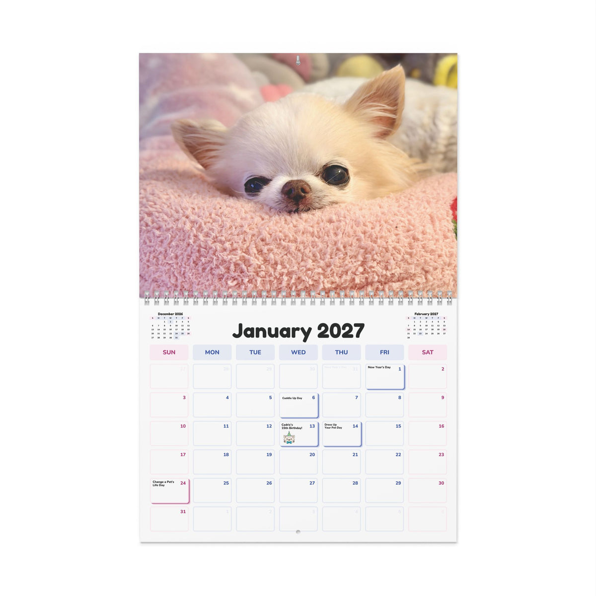 January 2027 calendar page with a cream Chihuahua peeking over a pink blanket.