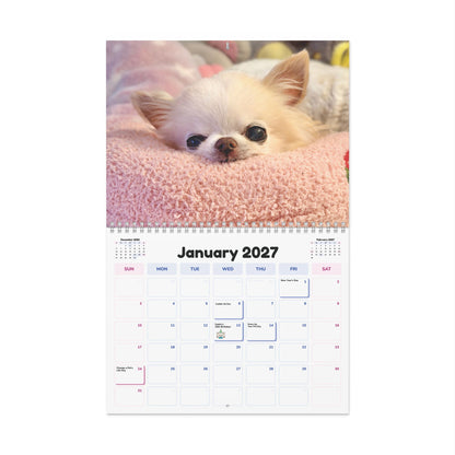 January 2027 calendar page with a cream Chihuahua peeking over a pink blanket.