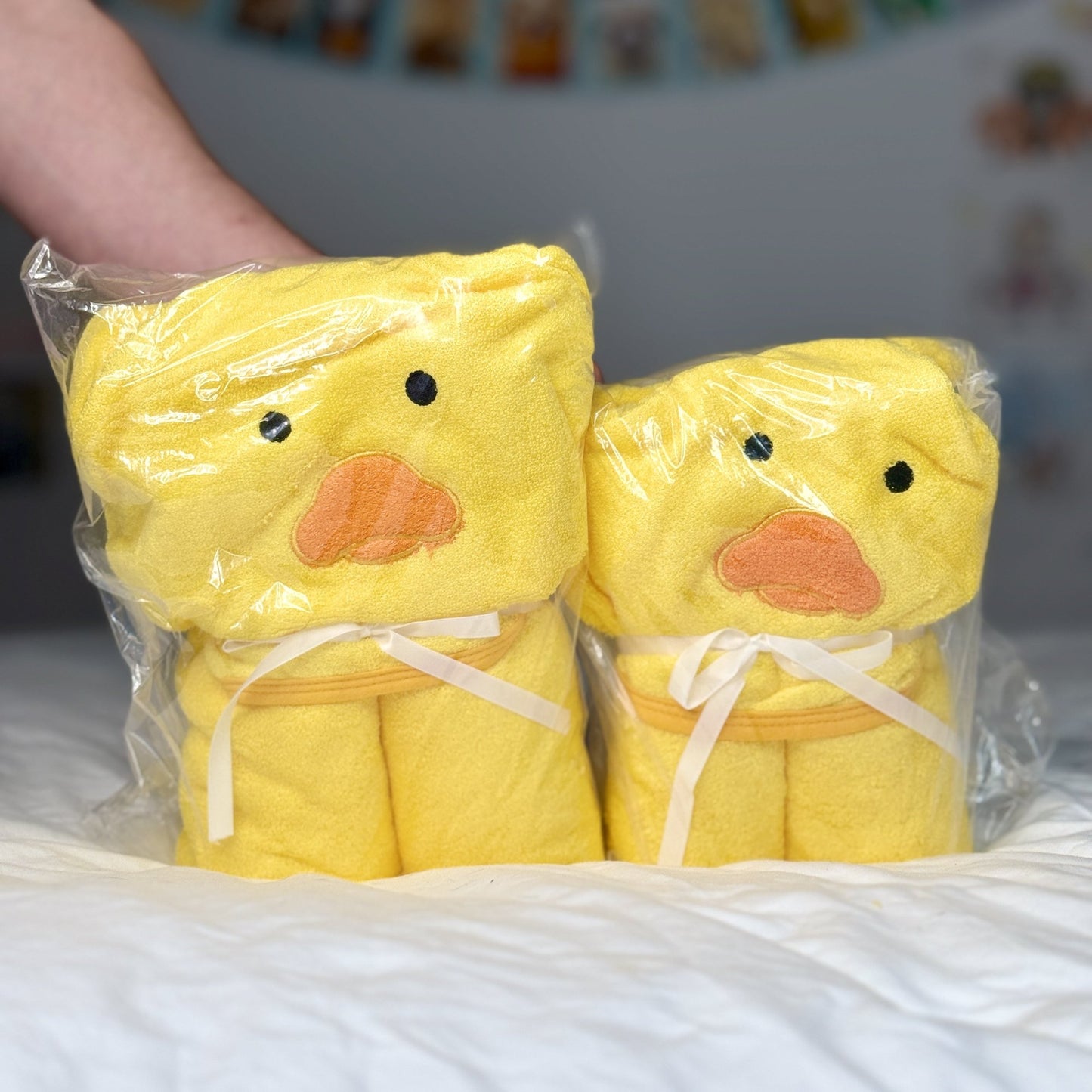 Cedric's Favourite Ducky Towel in packaging, showing both Small and Large sizes with duck face design.