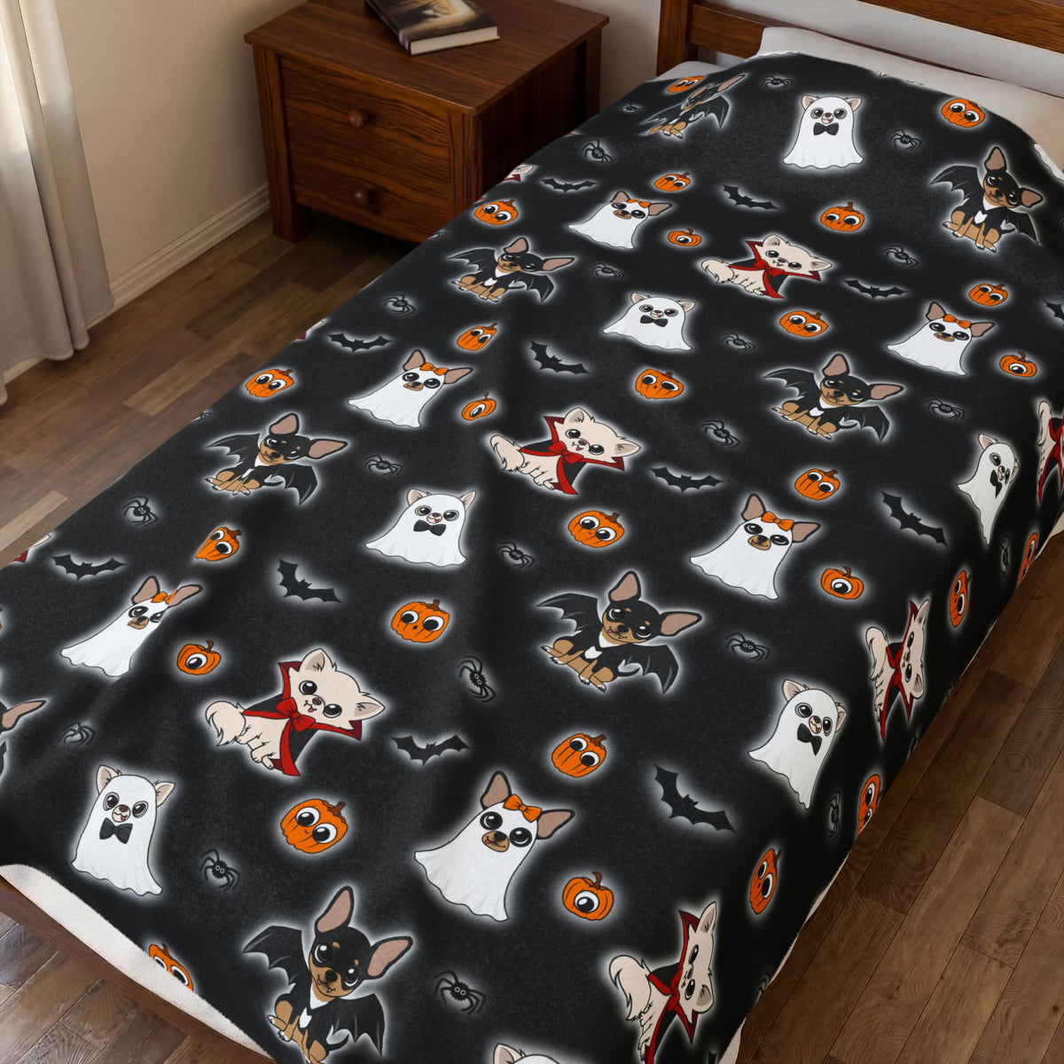 Close view of the Halloween Chis blanket spread across a bed, showing its black character print.