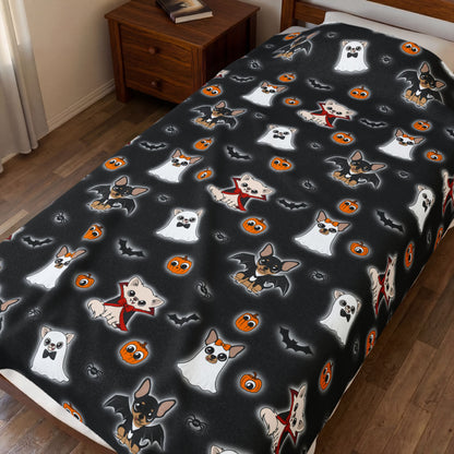 Close view of the Halloween Chis blanket spread across a bed, showing its black character print.