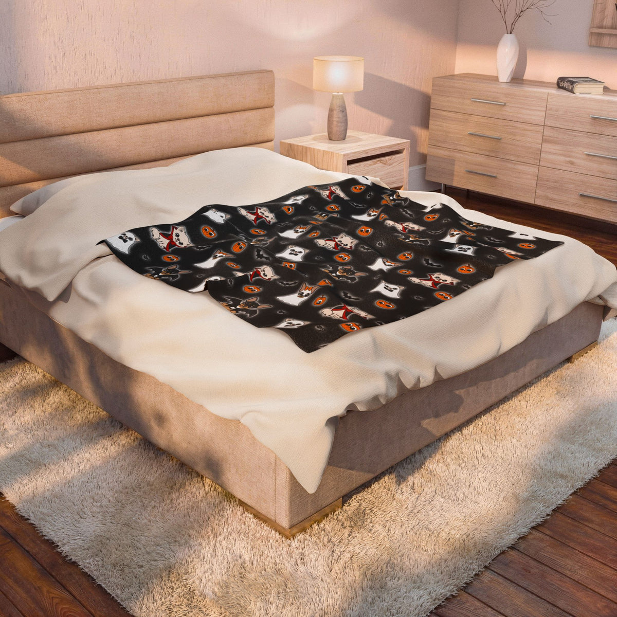 Halloween Chis printed blanket spread over the center of a bed with white bedding visible around it.