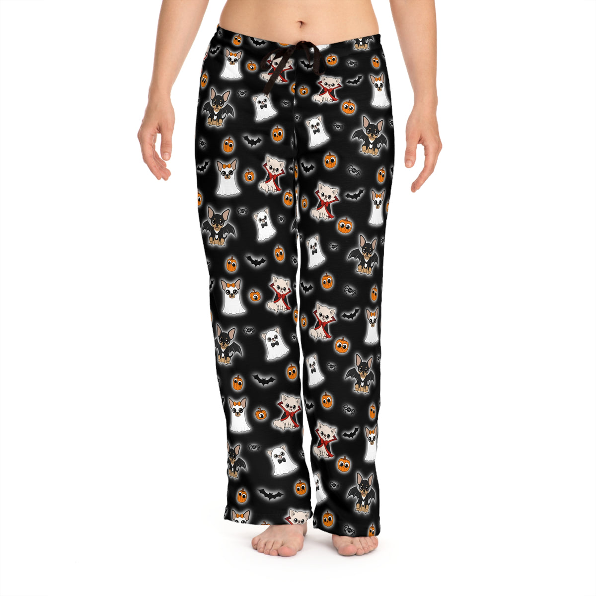 Model wearing black Halloween pajama pants covered in a repeating Chihuahua, pumpkin and bat pattern.
