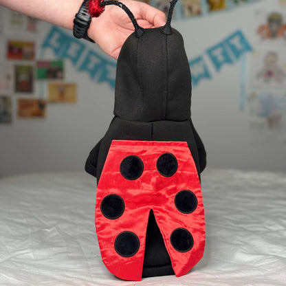 Close-up of the back design of Maya’s ladybug costume with red wings and black spots.