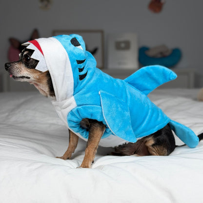 Side view of Maya in the blue shark costume with a tooth-edged hood, side fin and tail