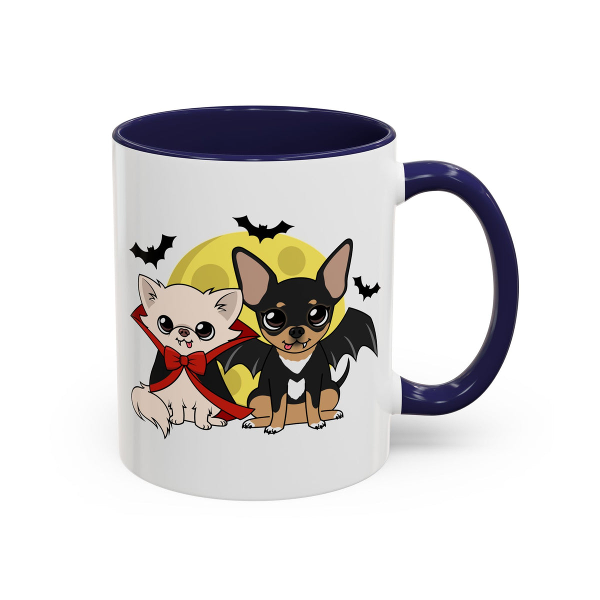 White ceramic mug with a navy blue handle and interior, featuring a cute illustration of two chihuahuas in front of a yellow full moon, one cream dog in a red cape and bow and one black-and-tan dog with bat wings, surrounded by small flying bats.
