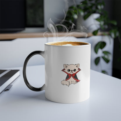 Steam rises from a color‑changing mug showing a cream chihuahua in a black cape with red lining and a red bow, sitting on a white background at the center of the cup.