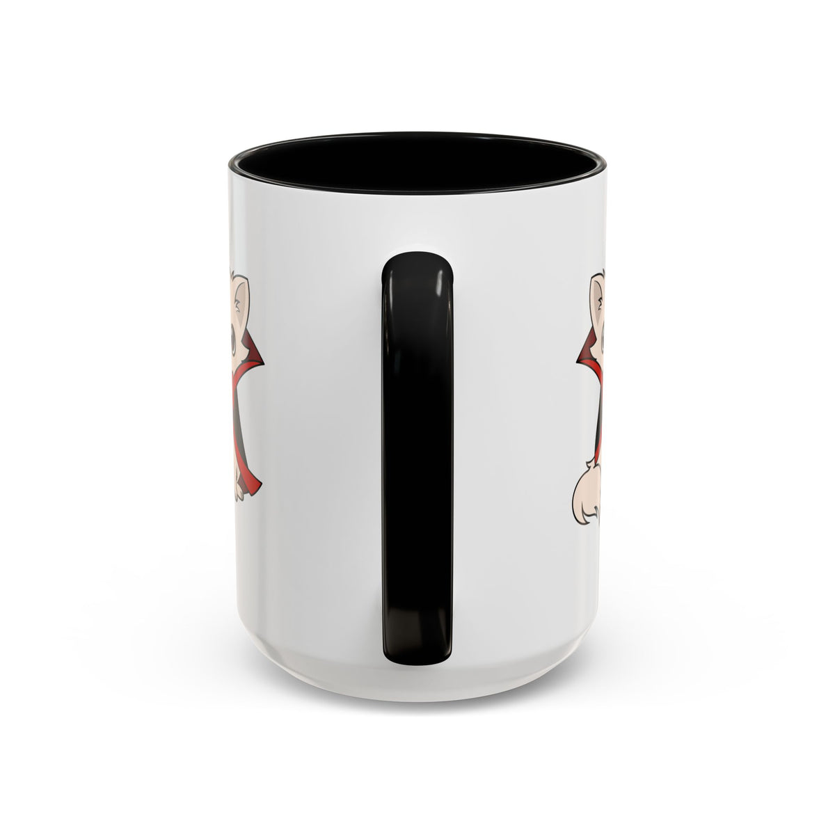 White ceramic accent mug with black handle and interior, showing partial illustrations of a small vampire chihuahua in a black cape with red lining on either side of the handle.