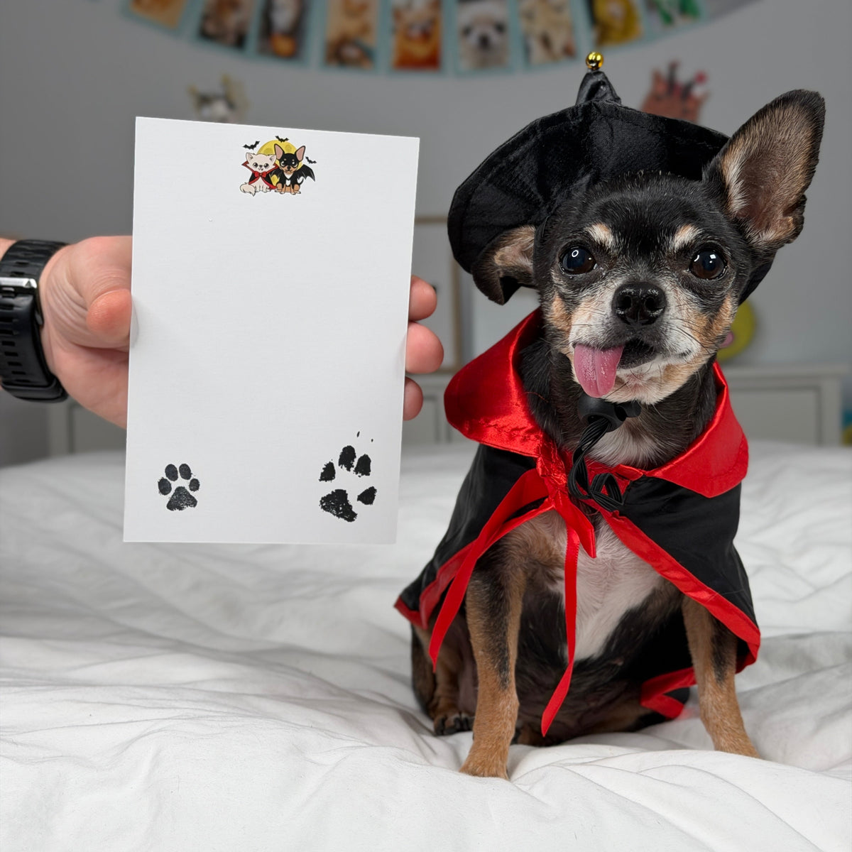 Reverse of the Vampire Chis Pawdograph photo card, with Cedric and Maya’s artwork and paw prints around a blank dedication area.