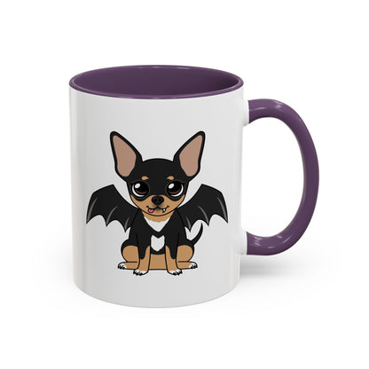 White ceramic mug with a purple handle and interior, featuring a cute black and tan chihuahua named Maya sitting with big round eyes, a tiny fang, a pink tongue, a white heart-shaped chest marking, and black bat-like wings on the side.